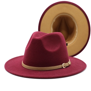 Detail view of burgundy wool fedora with khaki leather band and gold buckle accent