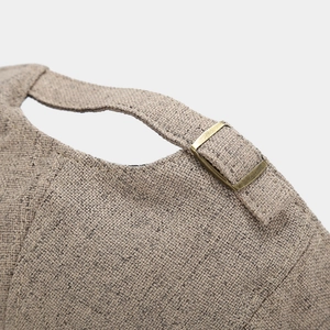 Detailed view of the linen newsboy cap back with an adjustable vintage brass buckle