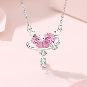 Detail of S925 sterling silver heart necklace with pink zircon planet pendant