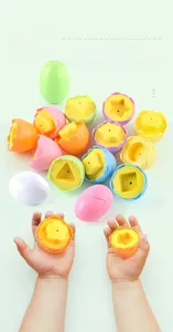 Detail of toddler hands matching colorful geometric shapes in Easter egg toy set