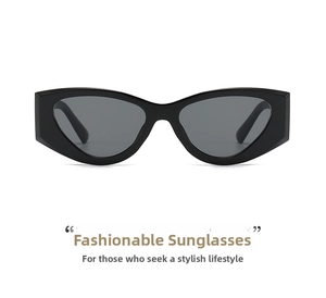 Detail shot of chunky black cat-eye sunglasses with thick frames and grey lenses