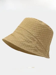Detailed texture of a khaki bubble fabric bucket hat with a stylish flat top structure