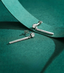 Macro detail of S925 sterling silver tassel earrings with sparkling zircon inlay