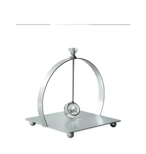Close-up of silver metal napkin holder with gravity weighted arm and crystal ball detail
