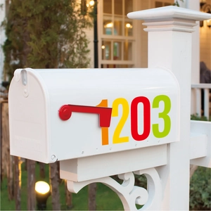 Outdoor white mailbox with colorful waterproof number stickers shown in a residential setting