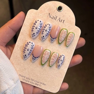 Detail of blue floral vines and green petaled flowers on 10pcs handmade press-on nails