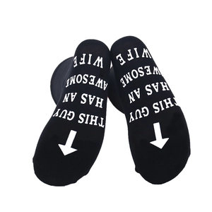 Detail of black cotton socks featuring This Guy Has An Awesome Wife print on the sole