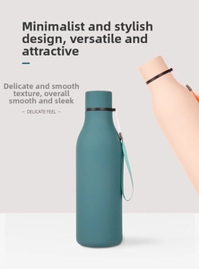 Detail of matte finish dark green and pink insulated bottles with portable carry loops