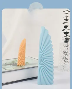 Artistic fan-shaped scented candles with radial pleated textures in soft Morandi colors