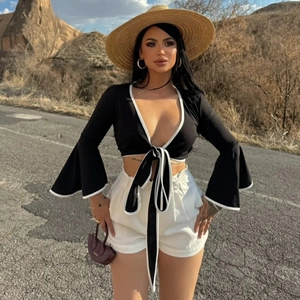 Sexy black deep V-neck crop top with flared sleeves and white piping for summer fashion
