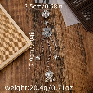 Macro detail of vintage silver plum blossom fan pendant with tassels and sizing