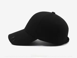 Detail view of black wool baseball cap with white cursive embroidery on the brim