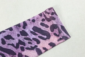 Detailed macro view of purple leopard print cuffs with high-quality double-needle stitching