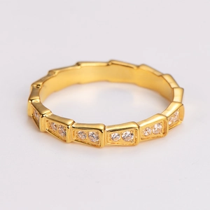 Macro detail of gold-plated snake-bone ring featuring full geometric zircon inlay stones