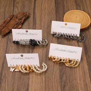 Detail view of assorted pearl and rhinestone earrings set on a display card
