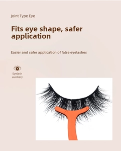Detail of ergonomic orange eyelash applicator with thick black magnetic lashes in display box