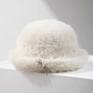 Plush faux fur bucket hat in cream white featuring a delicate silver bow accent