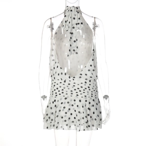 Detail of white polka dot halter dress featuring layered ruffles and backless design