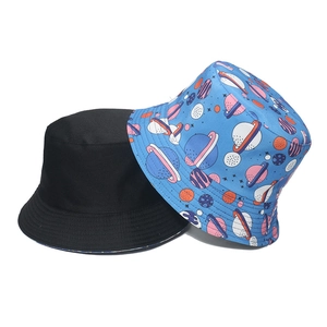 Detail of sun hat showing solid black design and blue galaxy planet print patterns
