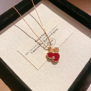 Elegant gold chain necklace with red enamel gourd pendant and single zircon accent