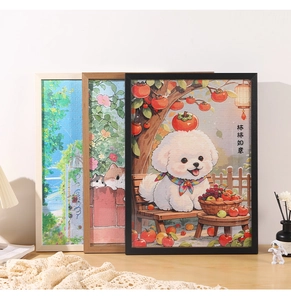 Three minimalist wooden frames with jigsaw puzzles displayed on a desk with warm lighting