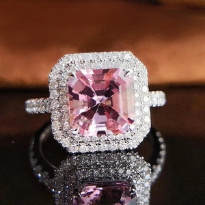 Macro detail of radiant cut pink zirconia ring with luxury pave-set diamond accents