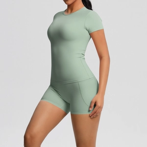 Detail view of the sleek sage green short sleeve yoga set featuring a form-fitting cut