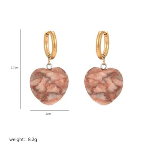 Macro detail of heart-shaped stone earrings with dimensions 3.7cm height and 2cm width