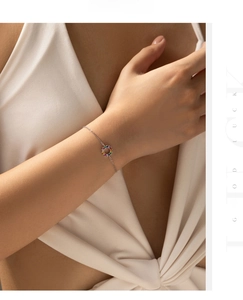 Close-up of S925 sterling silver bracelet with rainbow gemstone circle on female wrist