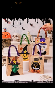 Detail of four Halloween non-woven gift bags featuring witch, pumpkin, skull, and black cat