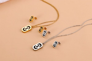 Close-up of gold and silver paperclip link jewelry sets with black oval pendants