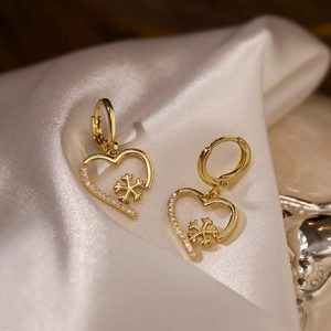 18K gold plated heart earrings with snowflake zircon pattern on white silk background