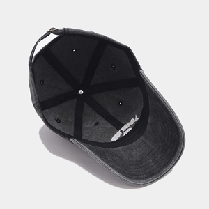 Internal structure of washed grey cotton baseball cap with seam reinforcement and metal buckle