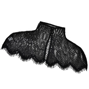 Detail of black lace halter neck floral pattern with button closure and eyelash trim