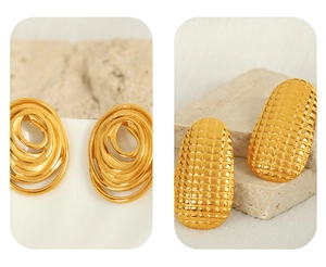 Macro detail of spiral ring and textured oval gold studs on stone pedestal