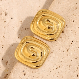 Detailed close-up of 18K gold plated square stud earrings with spiral texture and metal shine