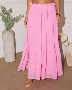 Detailed close-up of pink pleated maxi skirt with elastic high waist and ruffle trim texture