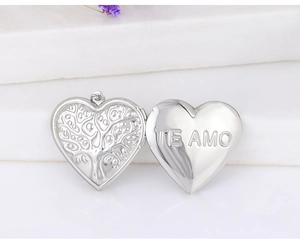 Detailed view of an open heart-shaped locket with Tree of Life and Te Amo engraving