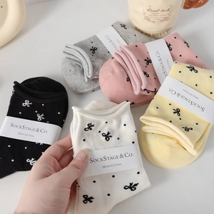 Five pairs of cotton mid-calf socks with bow patterns in black, grey, pink, yellow, and white