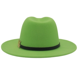 Detail of neon green fedora hat featuring black ribbon and golden leaf accessory
