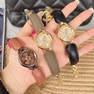 Three elegant leather and chain strap watches held by a model with a quilted bag
