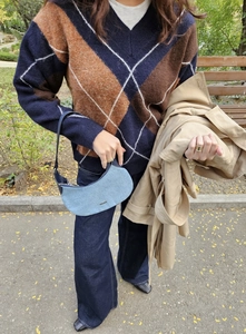 Close-up of vintage plaid V-neck knit sweater with denim shoulder bag details