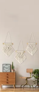 Close-up detail of three boho macramé wall hangings with natural cotton woven textures