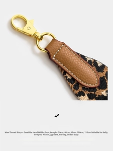 Macro detail of leopard pattern woven shoulder strap with leather ends and gold hook