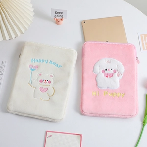 Detailed view of plush tablet sleeves with cute embroidered bear and puppy designs