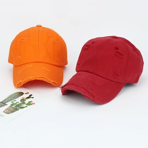Distressed cotton baseball caps in orange and burgundy with vintage ripped details