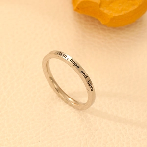 Macro detail of silver stainless steel ring featuring Faith, hope and Love engraving