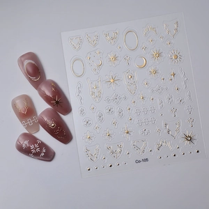 Detail of Co-105 nail stickers with gold celestial sun and moon patterns on pink nails
