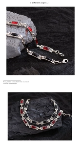 Detailed view of vintage bracelet with red and black crystals on rustic stone background