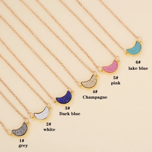 Multi-colored acrylic moon pendants on gold chains in various sparkling shades